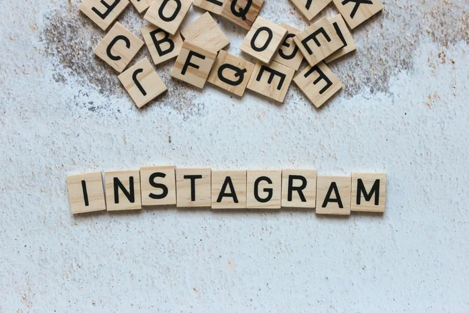 Wooden letter blocks arranged to spell 'Instagram' on a textured surface.